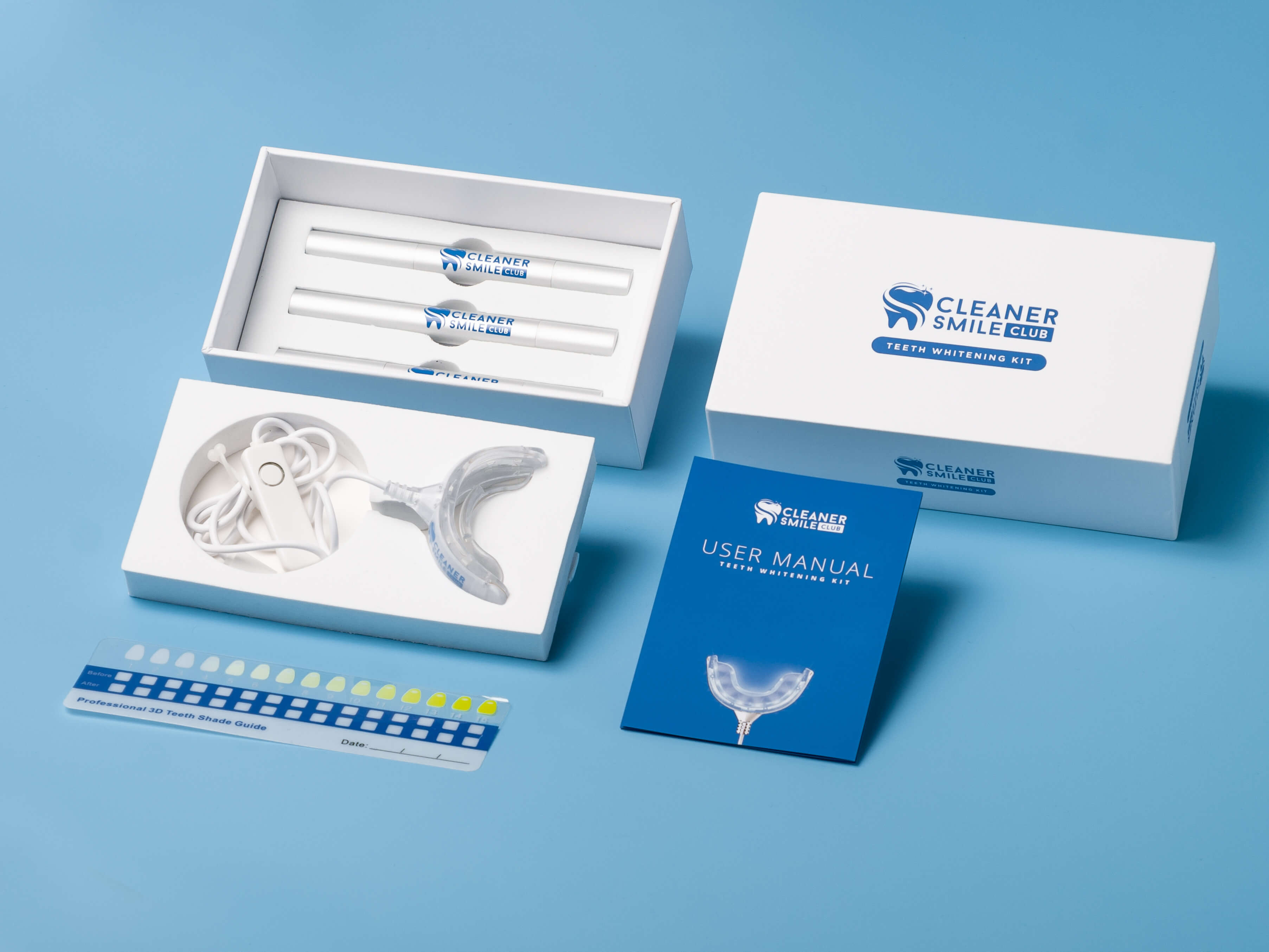 Whiten teeth fast whitening kit from Cleaner Smile Club on the blue background that consist from stripe, blue manual, led mouth piece in the white package and 3 silver whitening pens with blue logo of brand photo made by Fantastic Imago Branding, Advertising and Consulting Agency