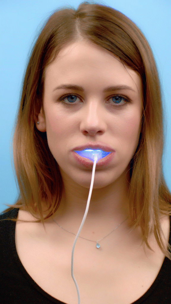 Gorgeous model removing LED mouth piece from her mouth from brand Cleaner Smile Club and she got instant teeth whitening and after teeth whitening treatment and she smile and also rinsed her mouth by clean water gif made by Fantastic Imago Branding, Advertising and Consulting Agency